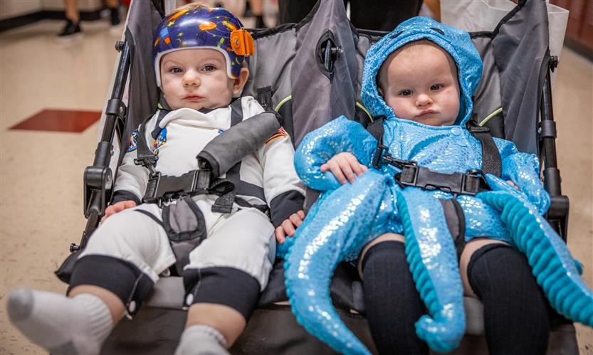 Children in costume trick or treat around school